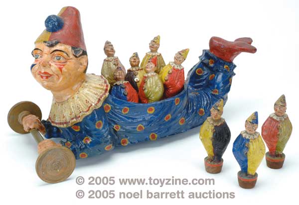 This papier-m&acirc;ch&eacute; creation is both a pull toy for a toddler and a set of nine-pins for bowling. The sculpting and excellence in artistry suggest German manufacture, since skittles sets made in France