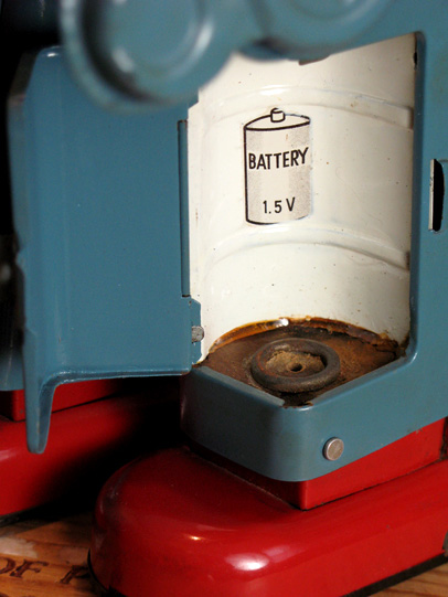 The battery box shows some mild corrosion. However, what looks like rust is in fact brown cardboard and old-school age-grime.